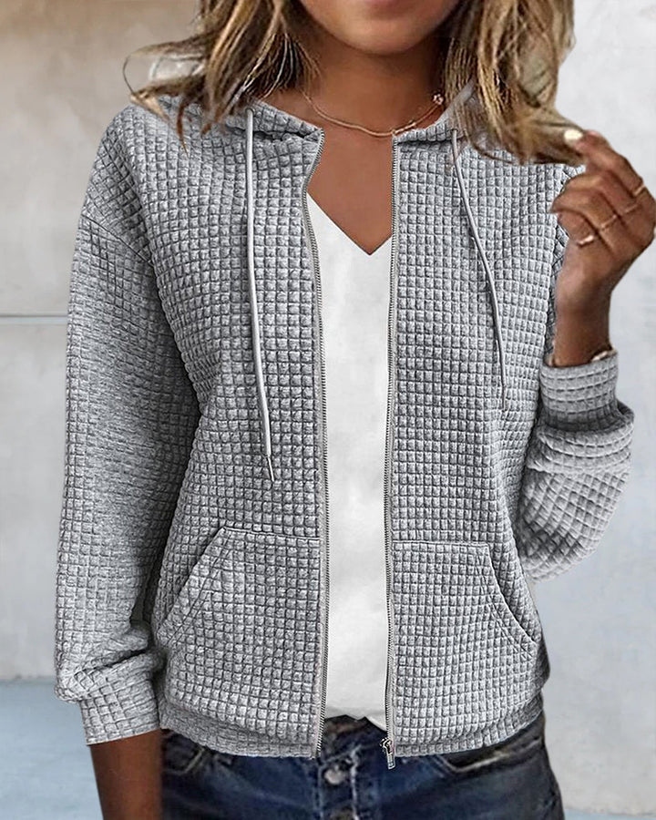 Casual women's outerwear vest in a solid color, offering a layered look with a full zip, pockets & drawstrings.