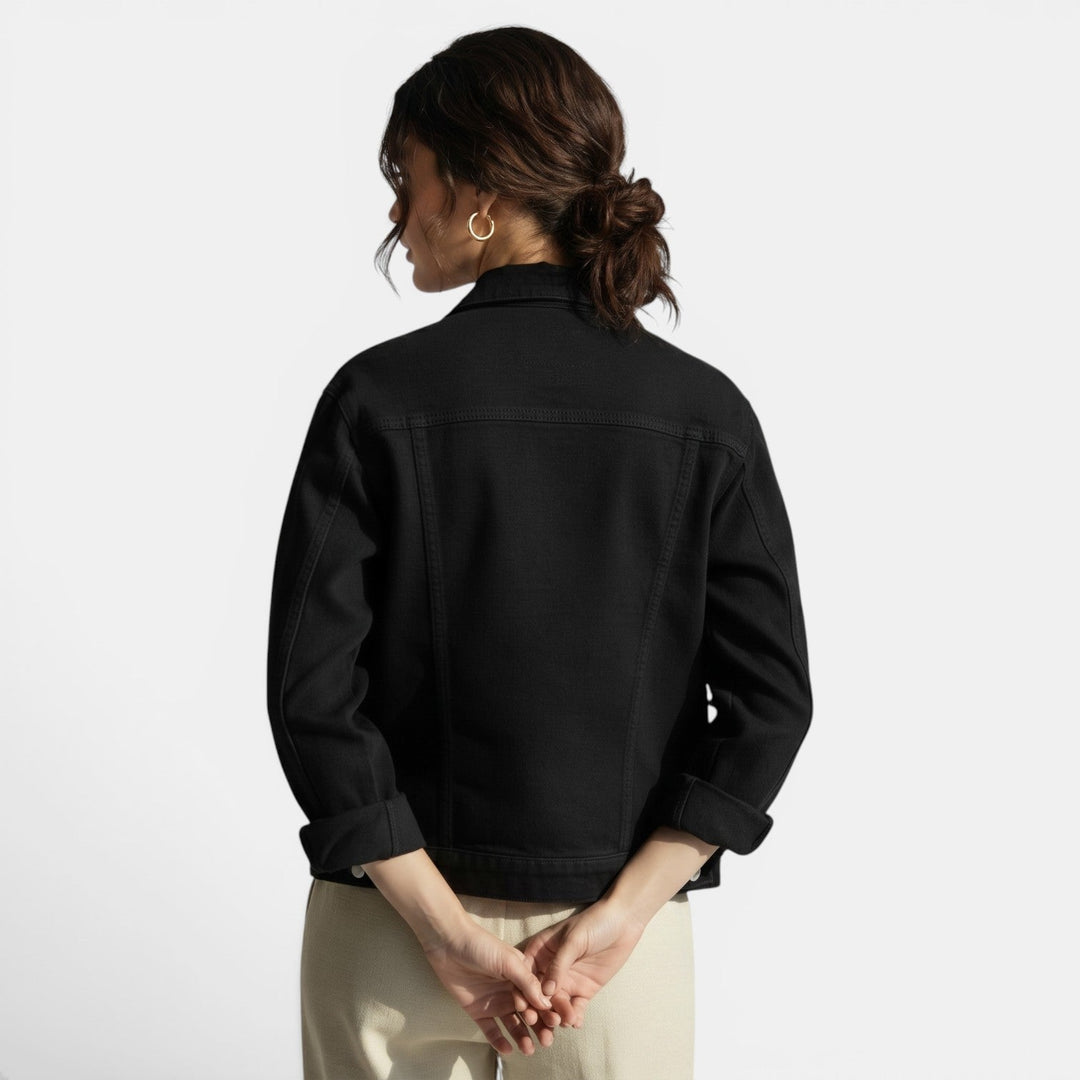 Woman wears a casual fitted jacket with jeans, embodying effortless urban style & contemporary weekend fashion.