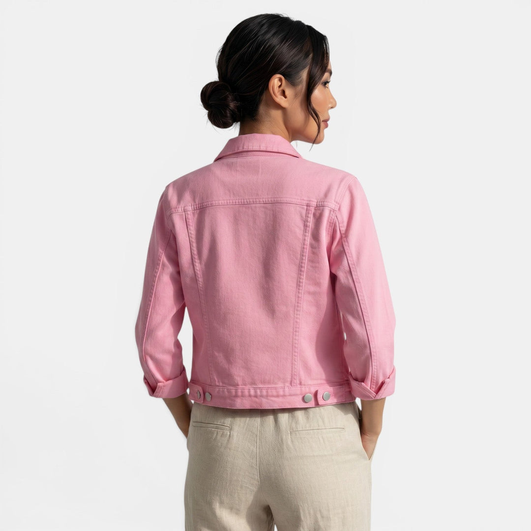 Woman confidently walking in a casual fitted jacket, embodying urban style & chic weekend fashion.