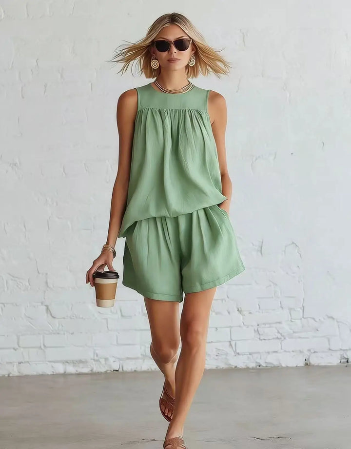 Chic women's two-piece set featuring a relaxed fit gathered top & high-waist shorts for casual summer style.