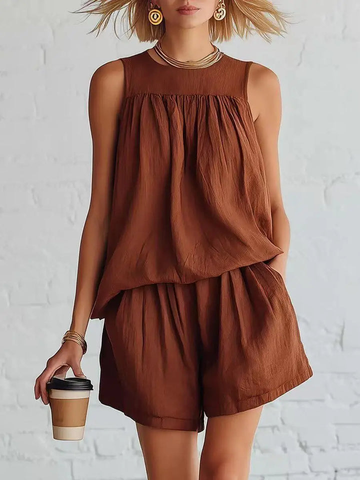 Effortlessly chic women's two-piece summer outfit with a gathered top and high-waist casual shorts.