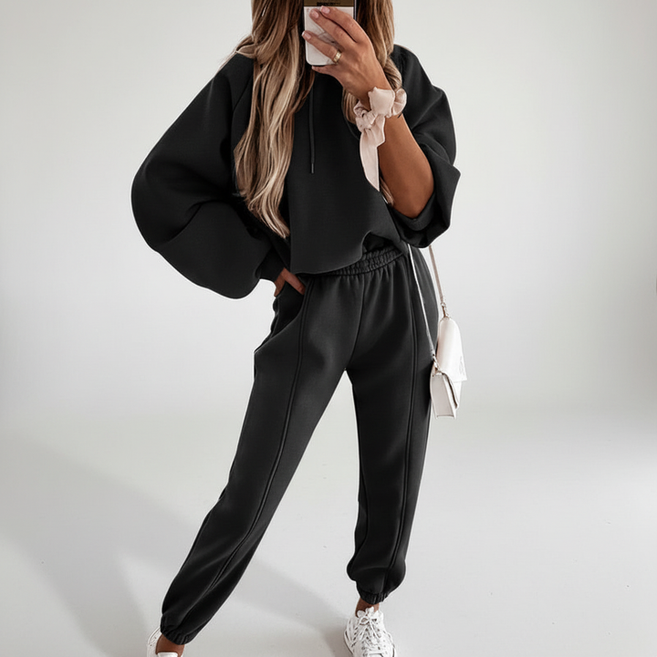 Side view of a woman in the 'Carla' hoodie and pants set, highlighting the relaxed fit and style