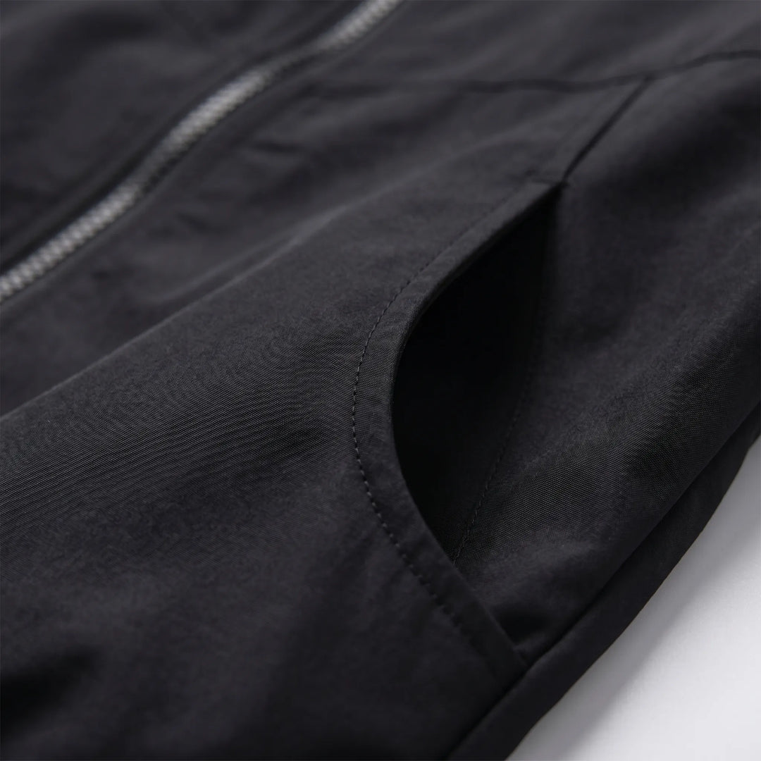 Versatile women's hooded windbreaker jacket for spring & fall. Casual, lightweight outerwear with zipper closure.
