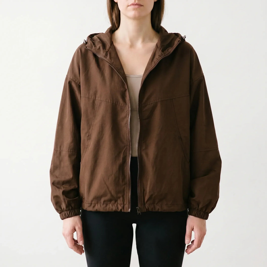 Comfortable women's hooded windbreaker with full zipper. Lightweight casual outerwear, great for active spring/fall.