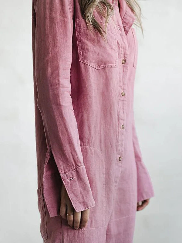 Woman walking in a casual long sleeve button-up jumpsuit. Comfortable, relaxed fit one-piece for active everyday wear.