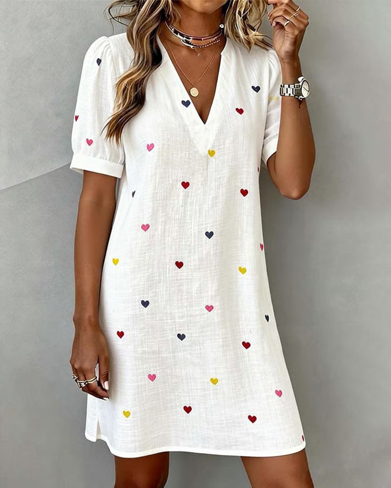 Women's casual mini dress with a charming heart print, V-neck, and stylish puff sleeves, perfect for summer.
