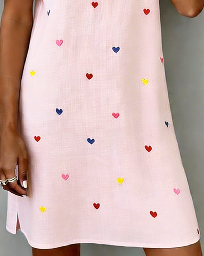 Front view of a model wearing a women's heart print casual V-neck mini dress with elegant puff sleeves.