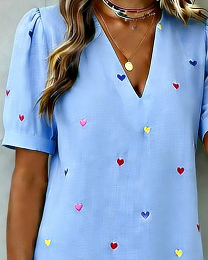 Chic and comfortable women's V-neck mini dress featuring a playful heart pattern and fashionable puff sleeves.