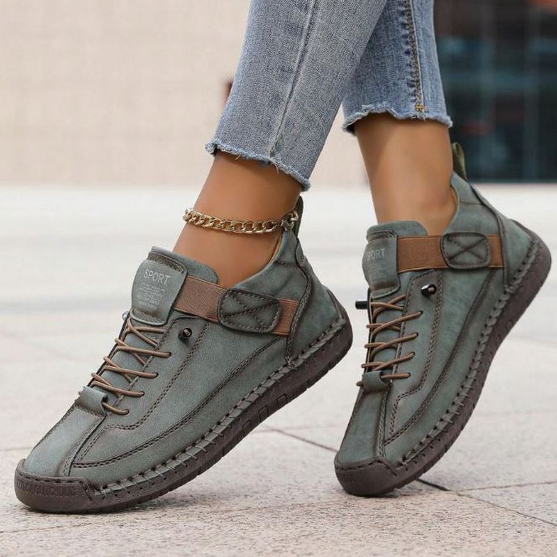Comfortable women's casual lace-up sneakers with stylish stitched details for versatile everyday footwear.