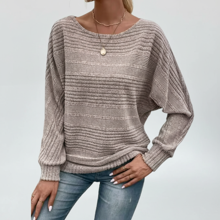 Soft knit women's sweater featuring classic stripes, perfect for everyday wear