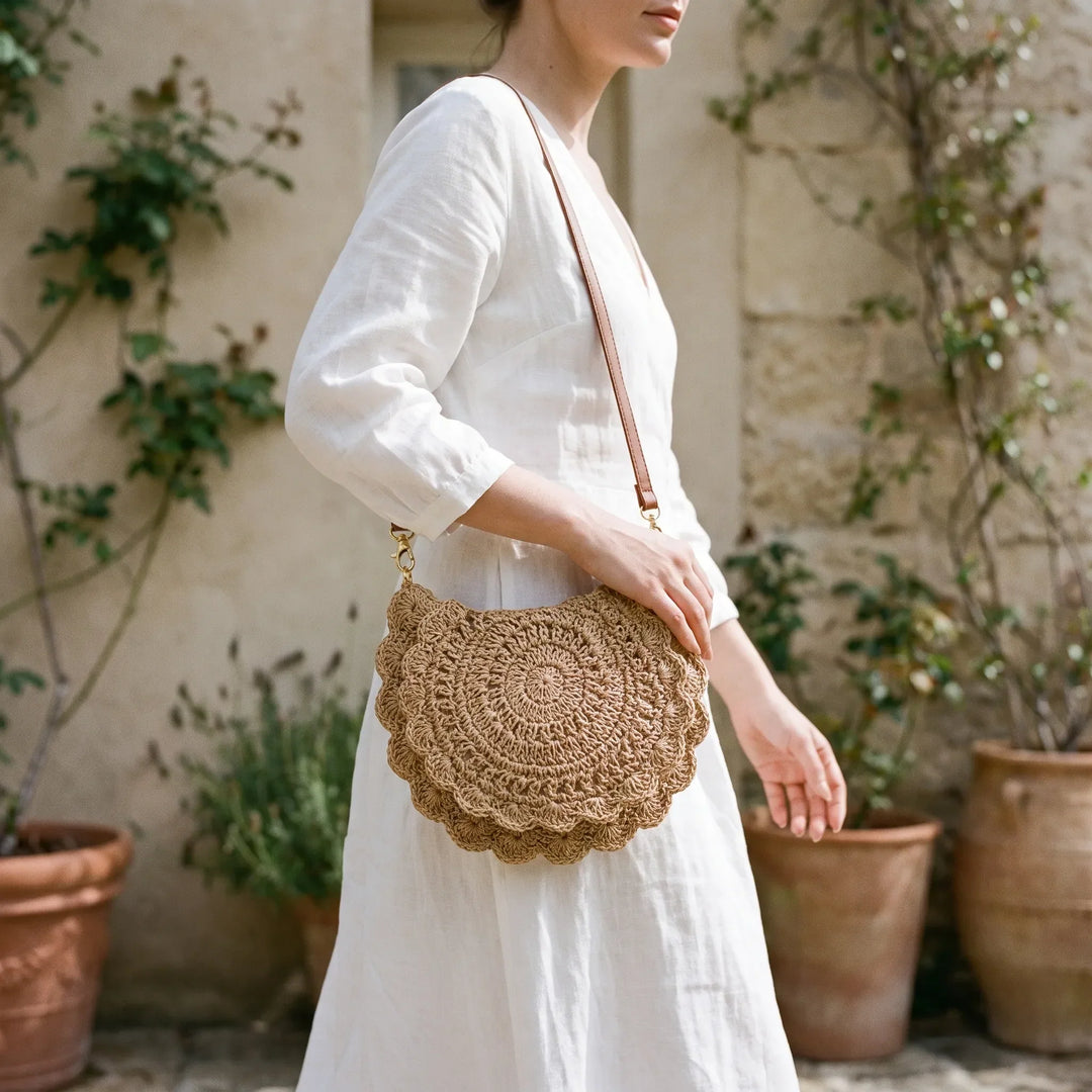 Women's casual woven crossbody bag with a unique scalloped flap, perfect for everyday wear.