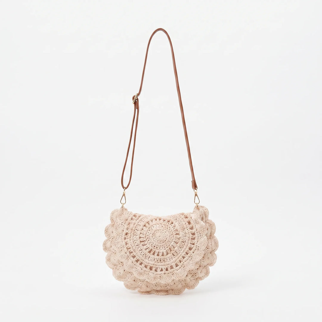Chic woven saddle bag for women with a decorative scalloped flap. A versatile casual shoulder or crossbody bag.
