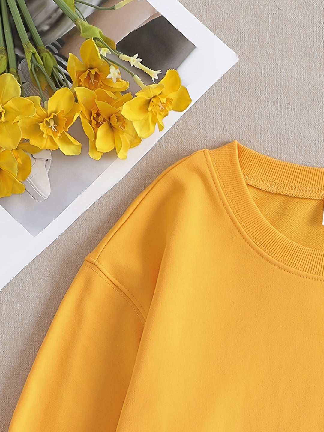 Playful yellow women's sweatshirt, long-sleeve, round-neck, with a funny graphic print. Ideal casual fall wear.
