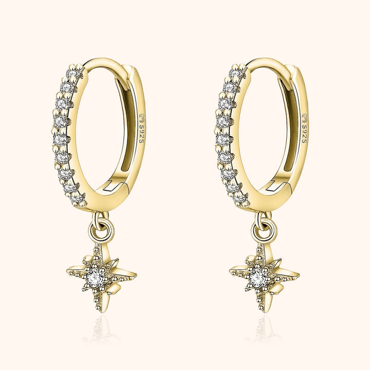 Close-up of women's celestial star hoop earrings, featuring detailed design and shining zirconia.