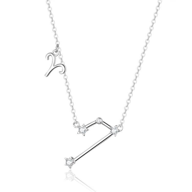 Woman's neck adorned with a delicate gold plated celestial zodiac necklace.