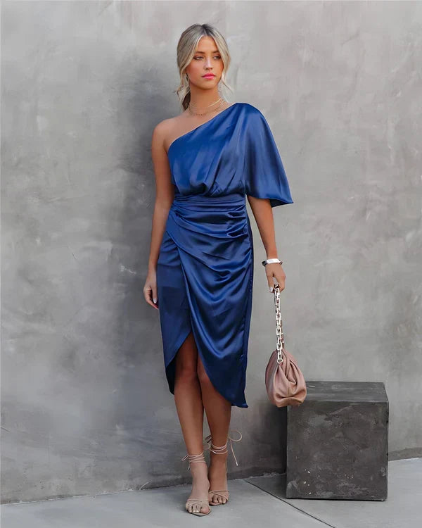 Woman in elegant pose wearing Celina evening gown, a beautiful long party dress for special moments.