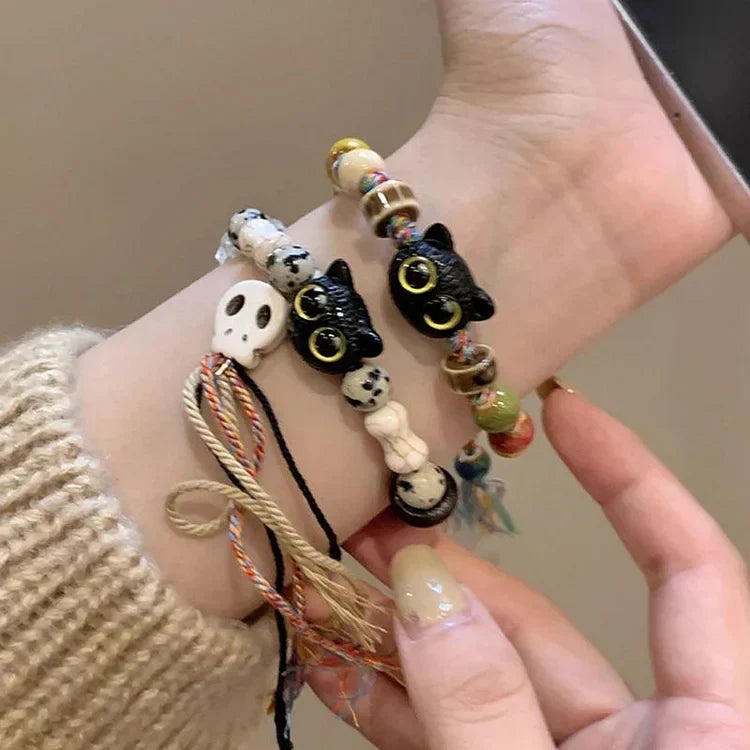 Selina women's unique charm bracelet with ceramic kittens, skull, & fringe. Handmade bohemian jewelry.