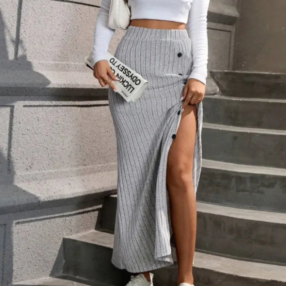 Detailed shot of the hem of a women's ribbed knit maxi skirt, highlighting the quality finish
