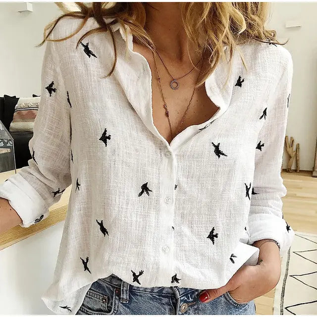 Relaxed fit women's blouse featuring a charming bird print. Button-up front, long sleeves, great for everyday wear.