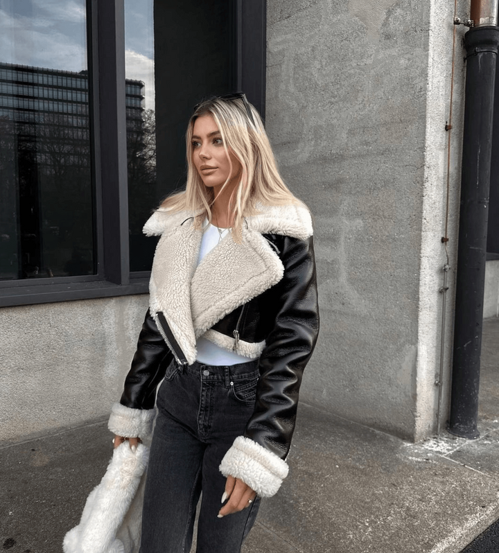 Elegant women's leather winter jacket with luxurious fur trim, perfect for chic cold weather style.