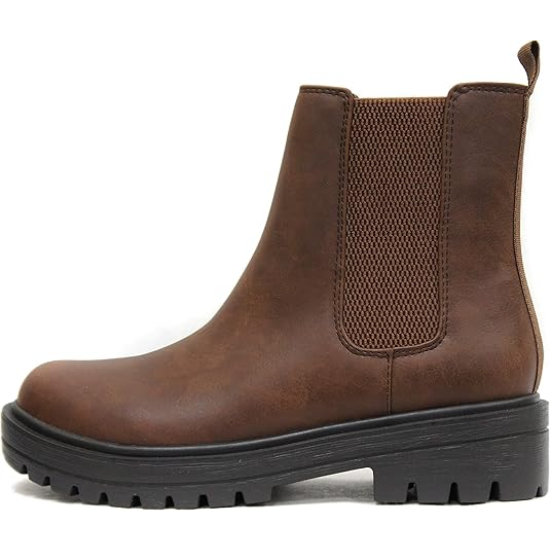 Close-up of the elastic side panel on chic women's low heel Chelsea ankle boots.