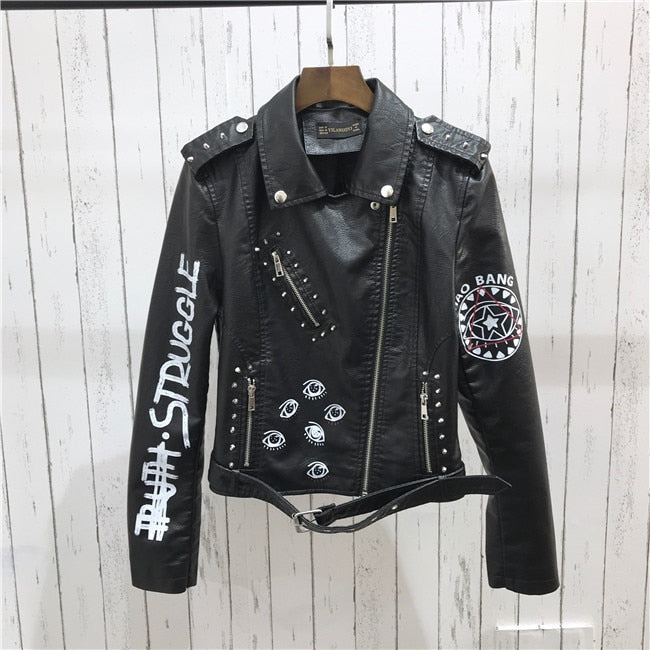 Back view of a women's stylish black moto jacket, showcasing its sleek fit and edgy design details.