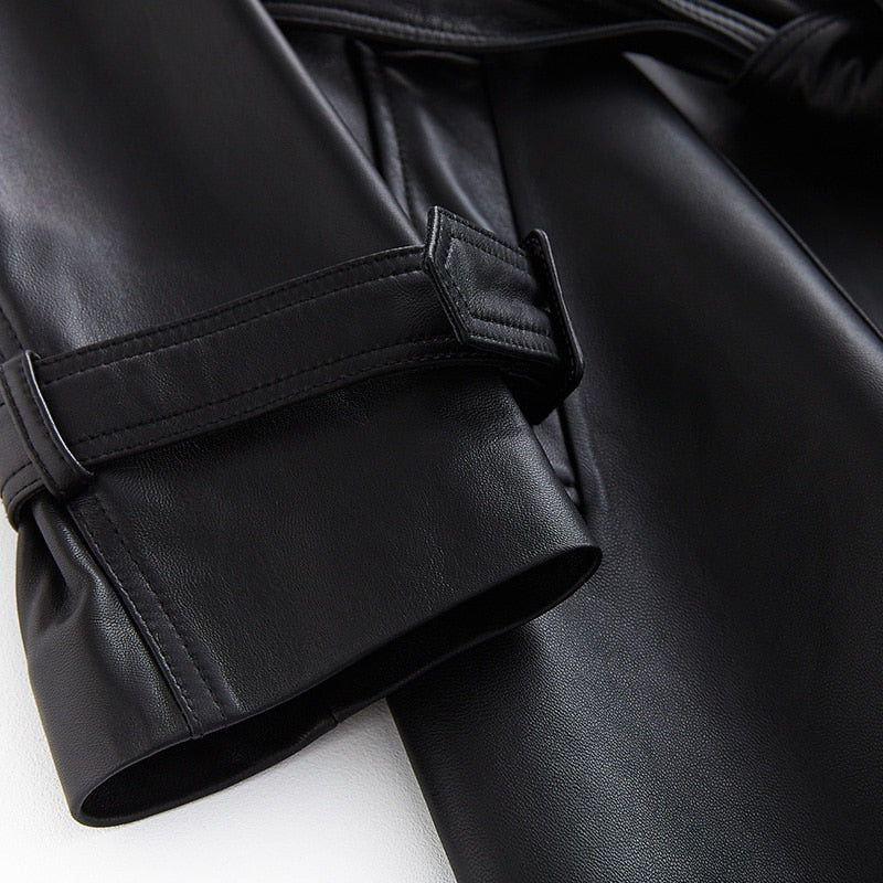 Chic women's black trench coat, elegant outerwear for a sophisticated look, classic fall style.