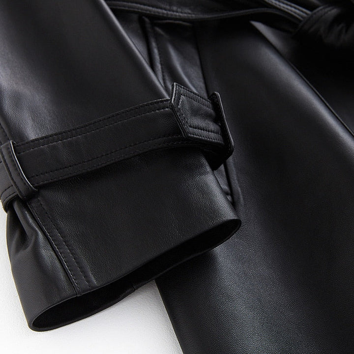 Chic women's black trench coat, elegant outerwear for a sophisticated look, classic fall style.
