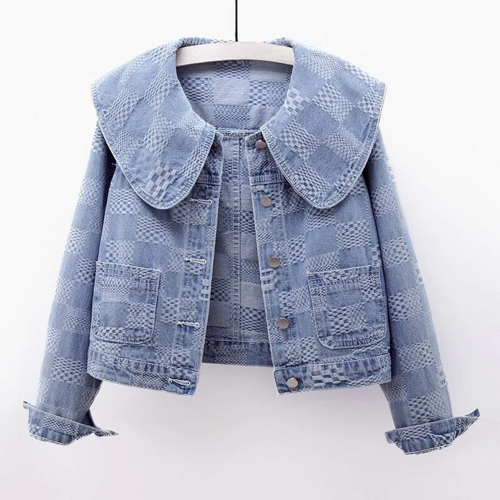 Fashionable women's cropped blue denim jacket, designed with a distinct oversized collar for a chic look.