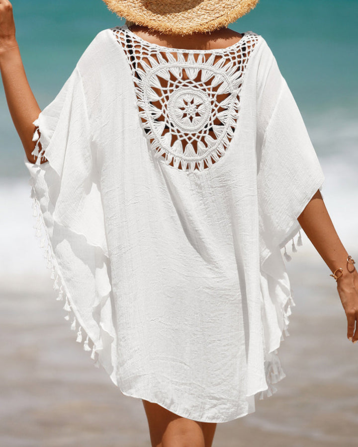 Women's chic boho beach cover-up dress in lightweight white crochet style with tassel details for summer.