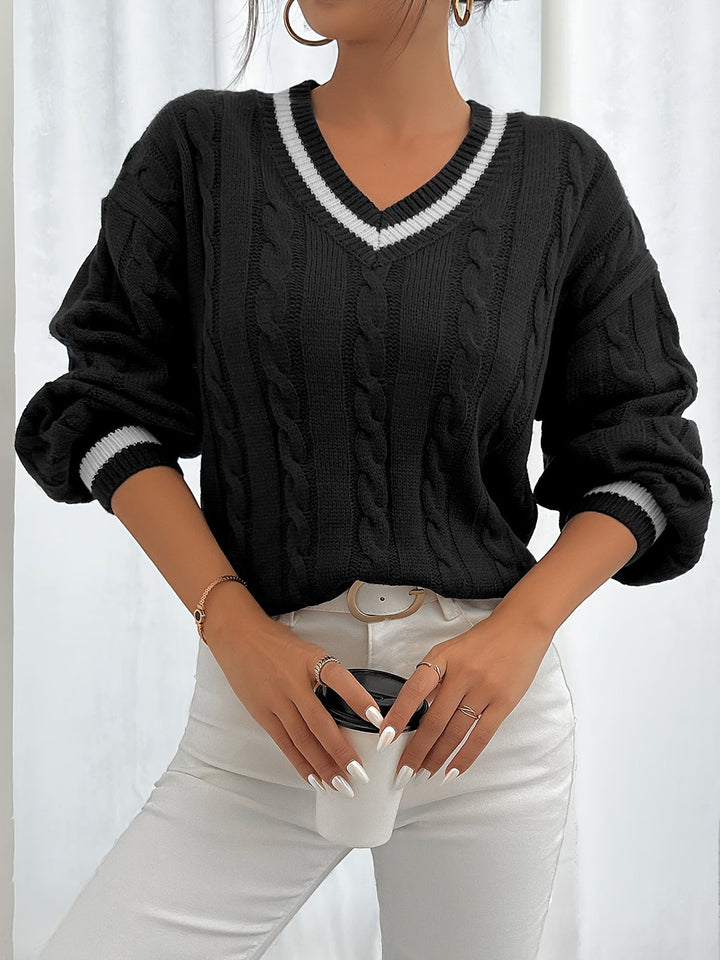 Women's chic cable knit V-neck sweater with elegant lantern sleeves. Cozy winter fashion knitwear.