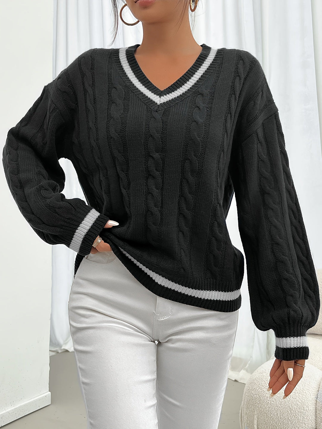 Aurora women's chic cable knit V-neck sweater with sophisticated lantern sleeves. Elegant winter comfort.