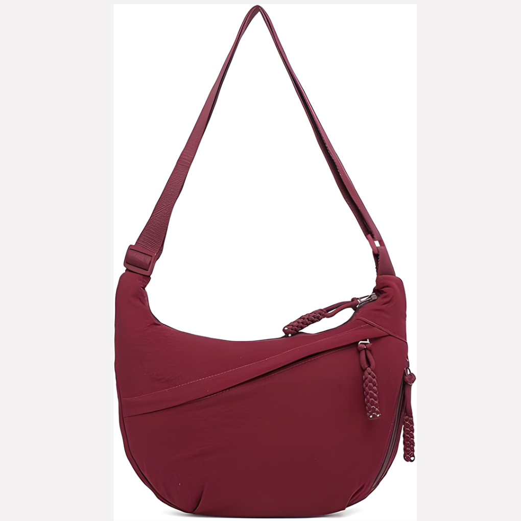 Close-up of the elegant braided strap on a women's stylish crescent shoulder bag.