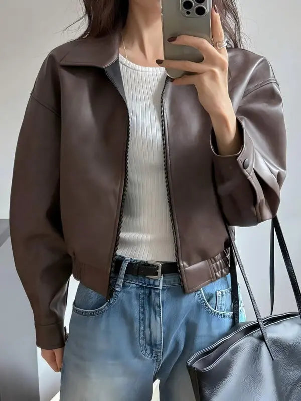 Elegant women's cropped jacket in a modern style, featuring a stand collar. Ideal outerwear for fall fashion.