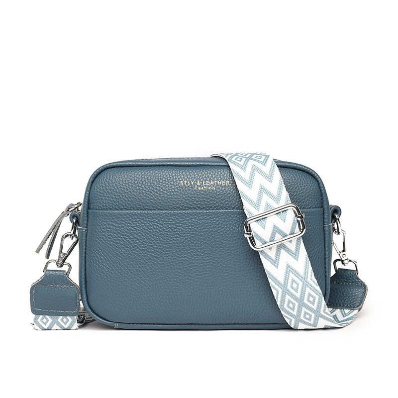 Chic everyday crossbody bag styled flat with travel essentials, a ready-to-go modern fashion accessory.