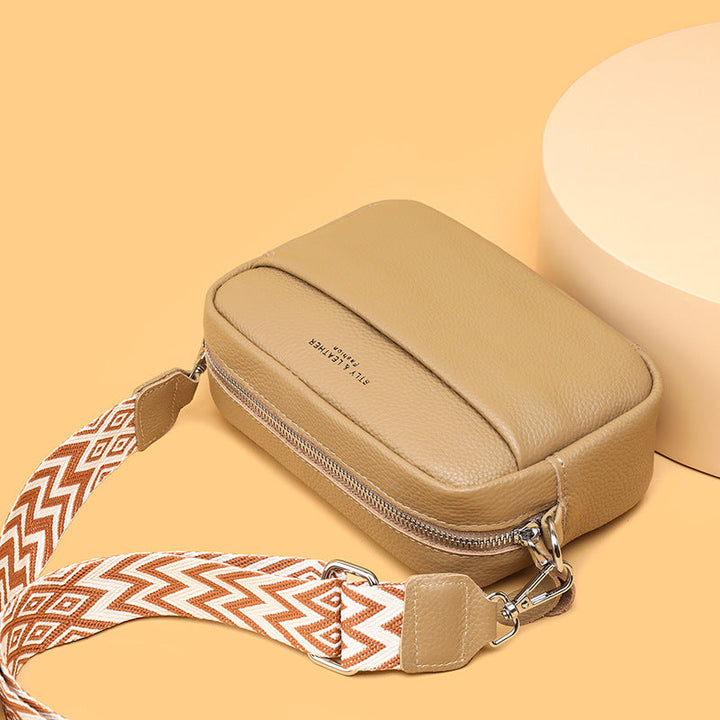 Open chic crossbody purse, revealing a spacious interior with pockets for all everyday essentials.