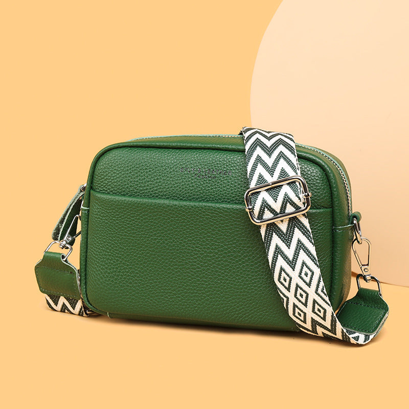 Elegant clasp and zipper detail on a women's modern crossbody bag, enhancing its chic & secure design.