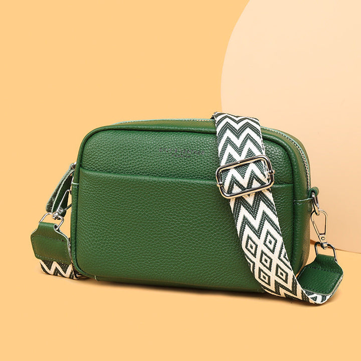 Elegant clasp and zipper detail on a women's modern crossbody bag, enhancing its chic & secure design.