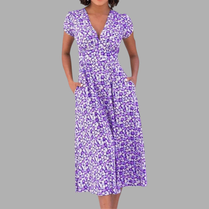 Casual women's short-sleeve midi dress, featuring a vibrant floral print, V-neck, and convenient side pockets.