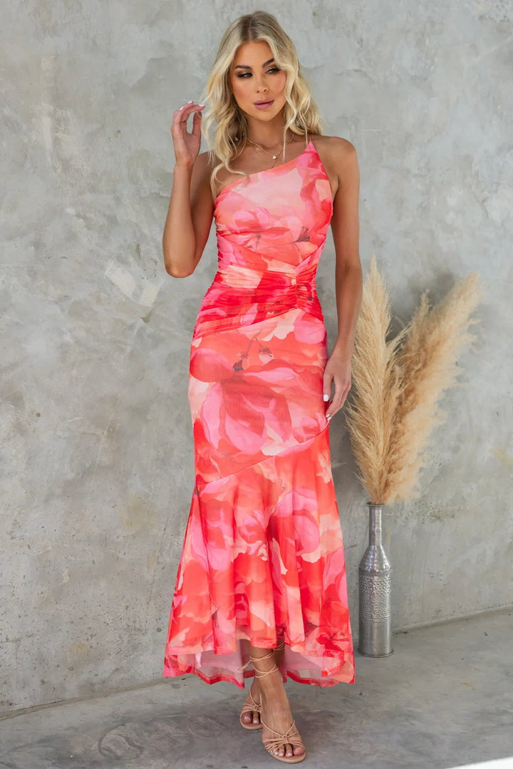 Red floral one-shoulder maxi dress. Stylish women's summer wedding guest or elegant cocktail party attire.
