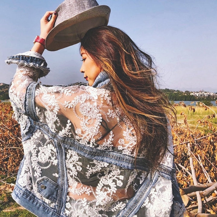 Classic blue denim jacket for women with chic frayed edges, ideal for casual fashion.