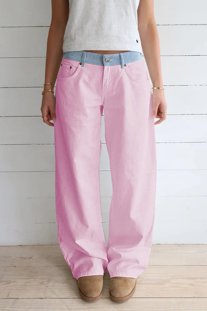 Woman wearing modern high-rise wide-leg jeans, showcasing relaxed fit & chic style for everyday wear.