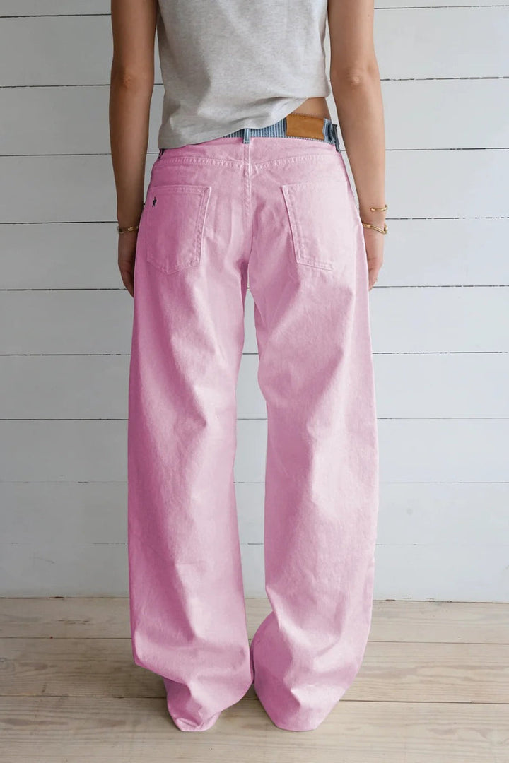 Close-up of high-rise wide-leg women's jeans fabric, highlighting quality & comfortable texture.
