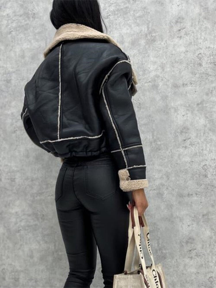 Cozy women's winter motorcycle jacket with soft sherpa lining & chic lapels. Zippered for warmth & style.
