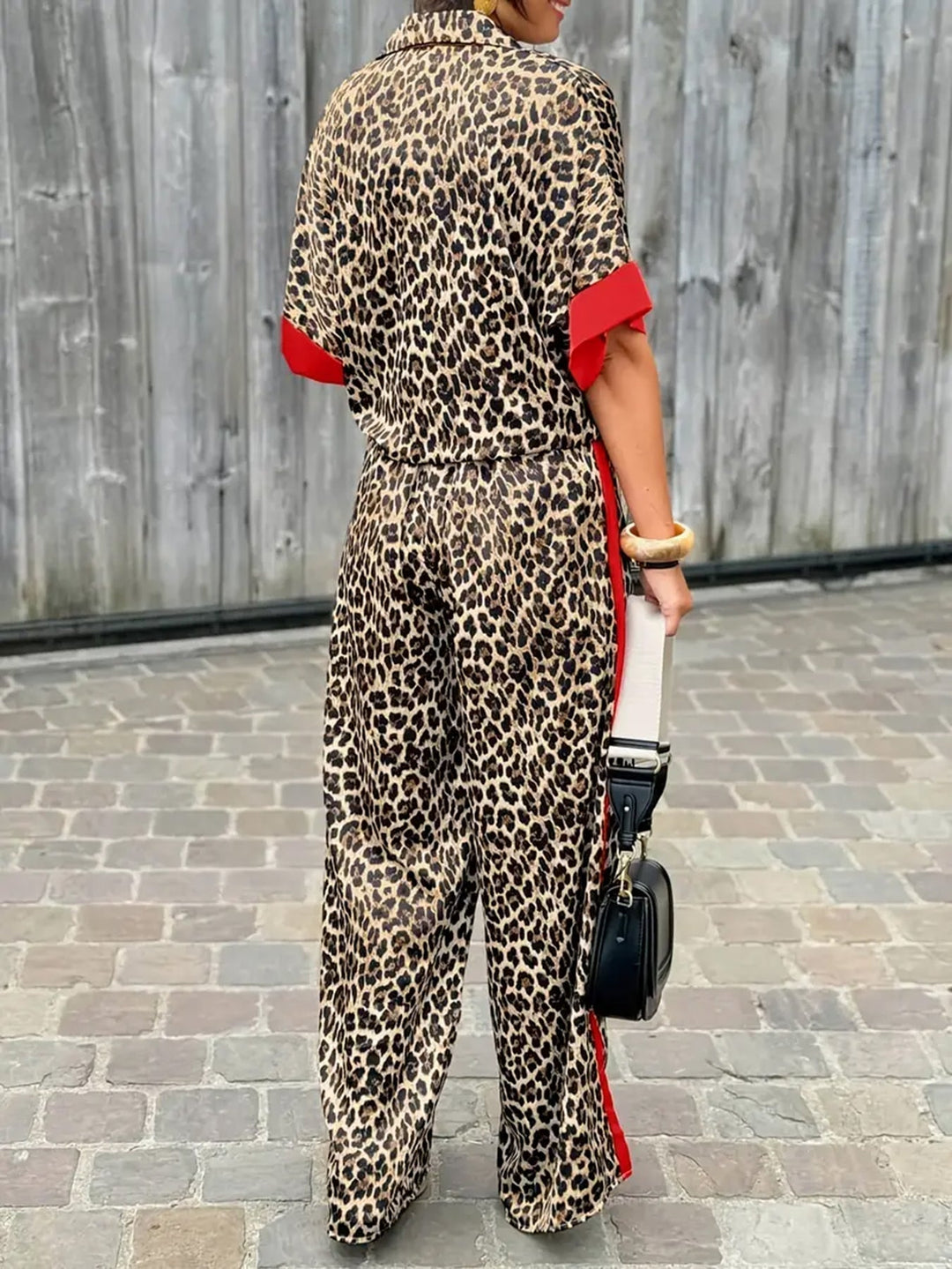 Stylish women's V-neck leopard print jumpsuit with comfortable wide legs. Perfect for fashion.