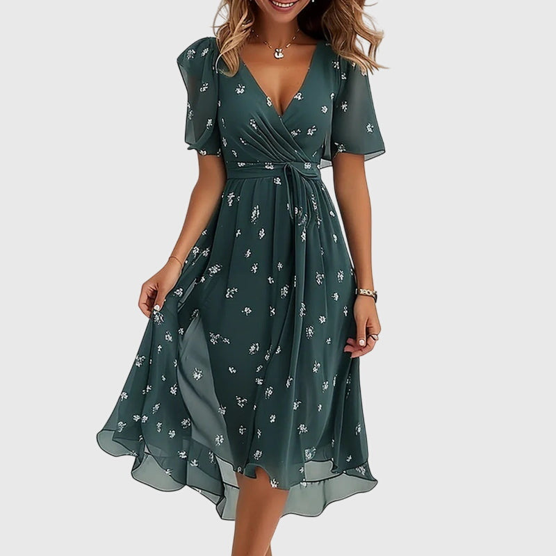 Elegant women's midi dress in a chic design, featuring a v-neck and flowing fabric for effortless summer style.
