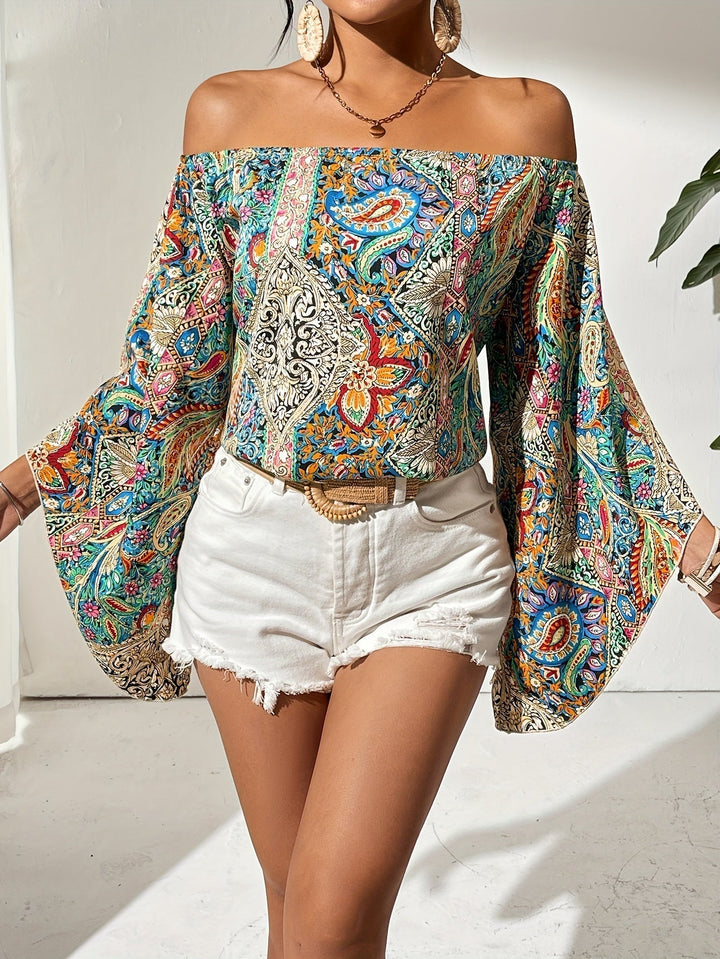 Women's chic off-shoulder blouse with vibrant geometric print, perfect for summer fashion.