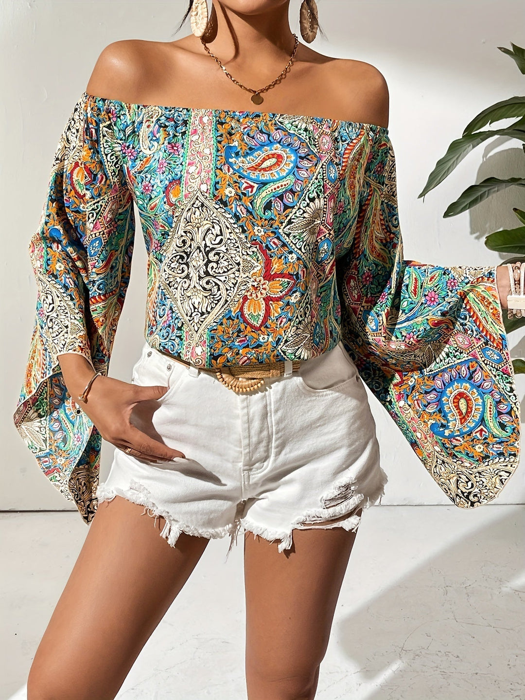 Casual women's off-shoulder fashion top with a vibrant geometric print, ideal for summer style.