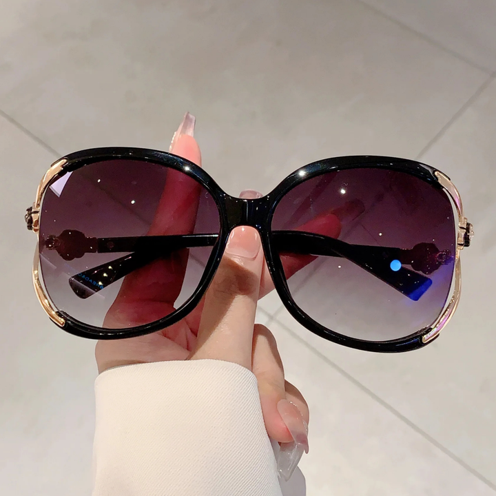 Elegant women's oversized sunglasses featuring gradient lenses for anti-glare and complete UV protection.