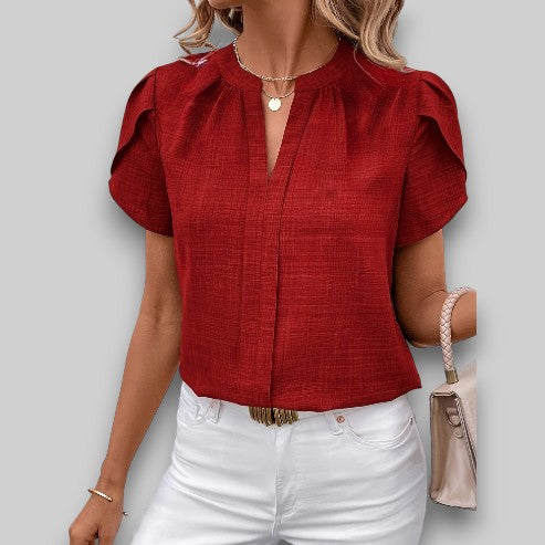 Elegant women's short petal sleeve blouse. Chic pleated neckline top, ideal for a stylish and comfortable look.